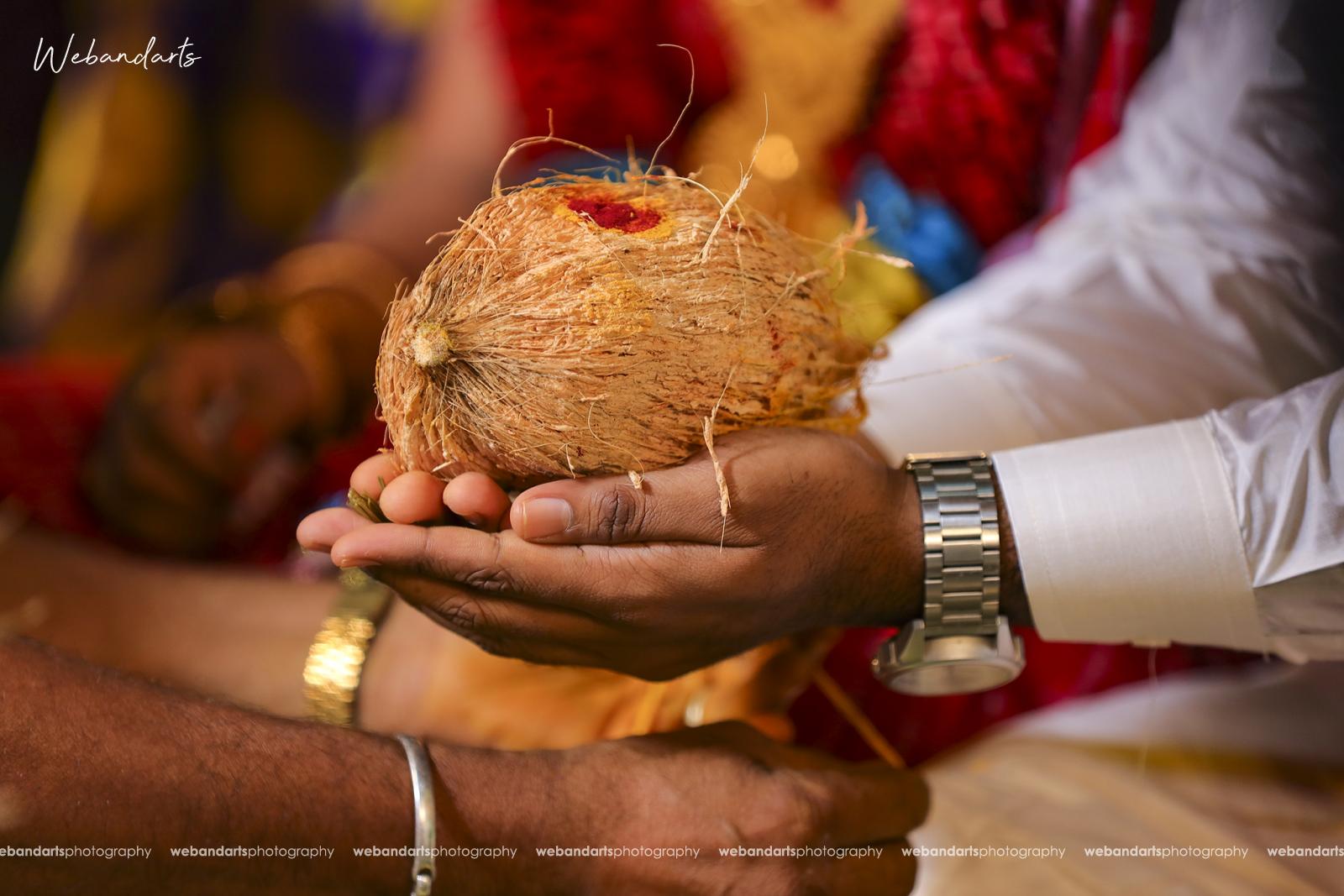 hindu_wedding_south_indian_rituals_coconut_couple_hands-1110